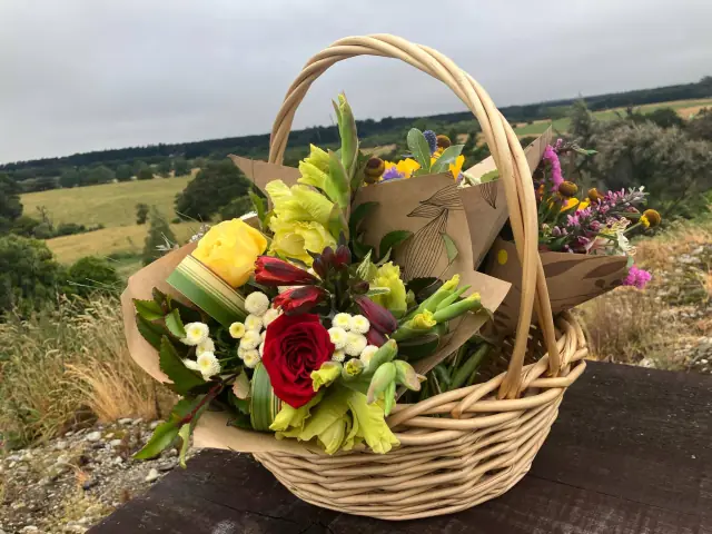 Mixed seasonal bunches in a wicker basket overlooking the South Wairarapa countryside